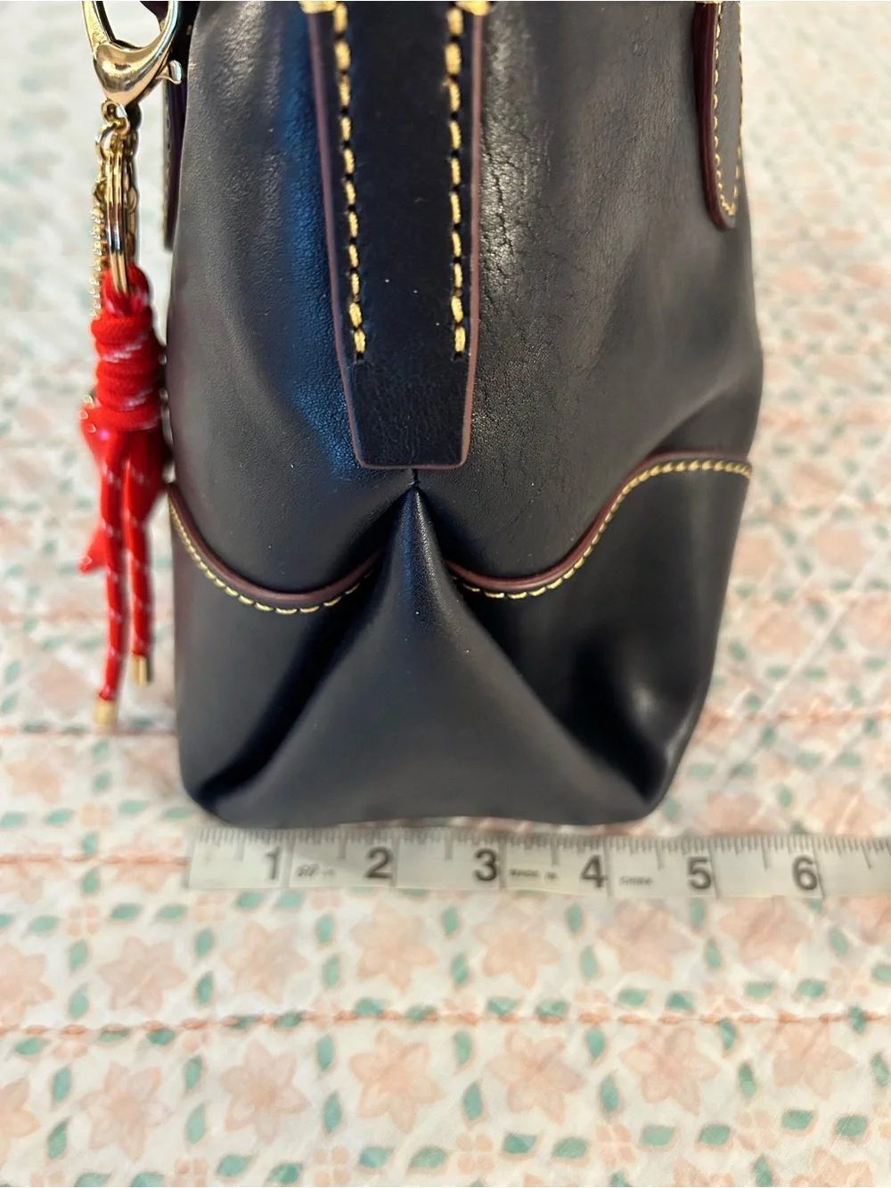 Dooney and Bourke Florentine Satchel 30 in the color Navy. EUC comes w/bag charm
